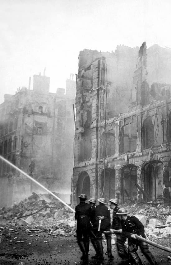 Firefighters attempting to put out a bombed out part of London during the blitz